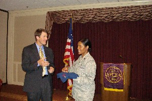 Special Agent Richard Lay, head of the Federal Bureau of Investigation's (FBI's) cybercrime unit, receives a token of appreciation from Col. Mary Gillam, USAF, chapter president, for speaking at the July meeting.